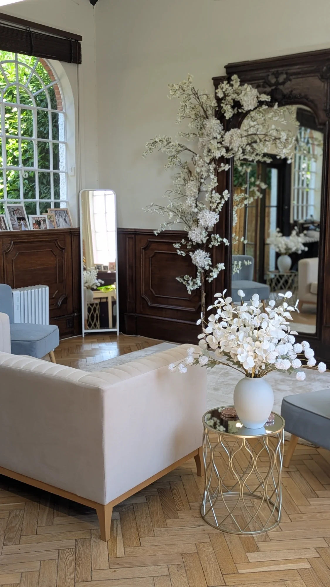 Bridal studio interior with high ceilings, floral decor and velvet seating for fittings