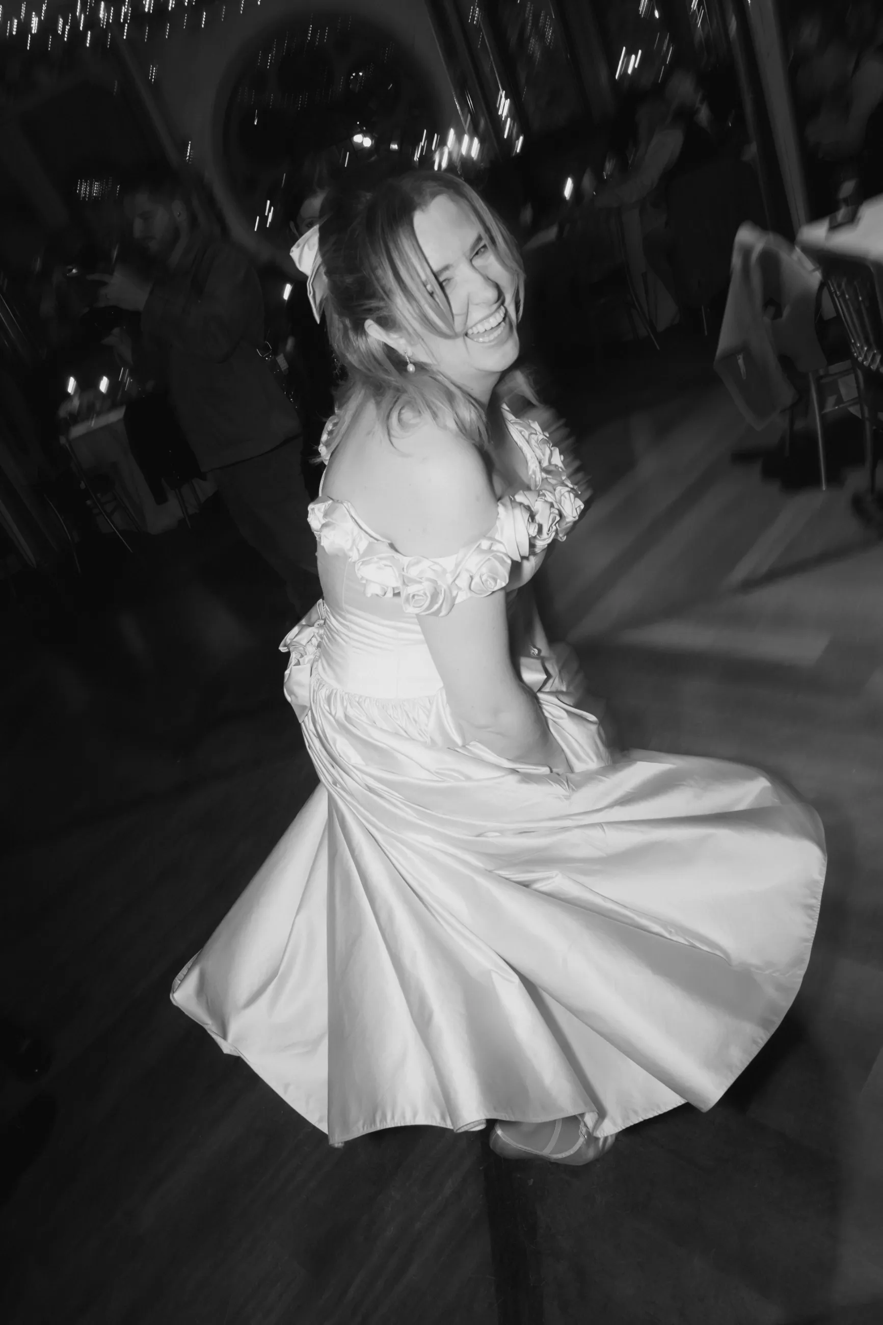 Flo twirling on the dance floor in her tea-length duchess satin ballgown