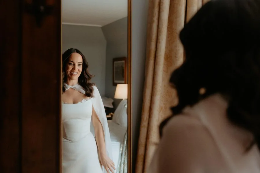 Custom bridal separates with a chiffon cape and peekaboo lace corset, made for a Scottish wedding