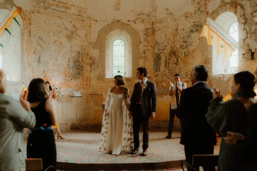 Custom white crepe wedding dress with a gold sequin cape, made for a London wedding