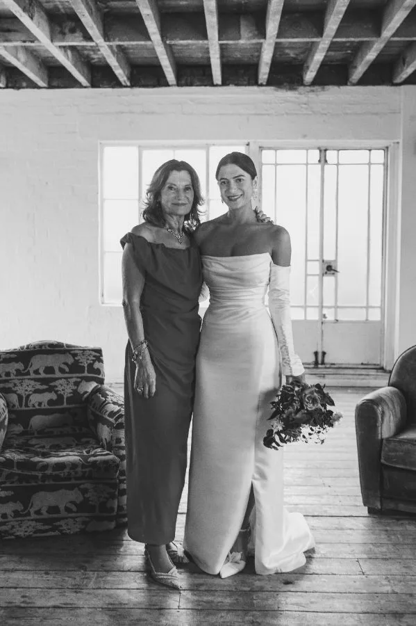 Custom corseted wedding dress with dynamic pleating and a leg split, made for a London bride