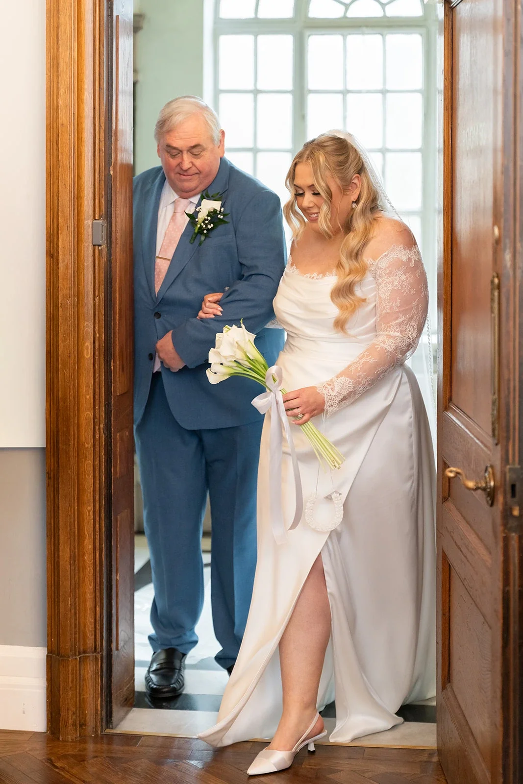 Custom silk satin corseted wedding dress with a side split and chantilly lace sleeves