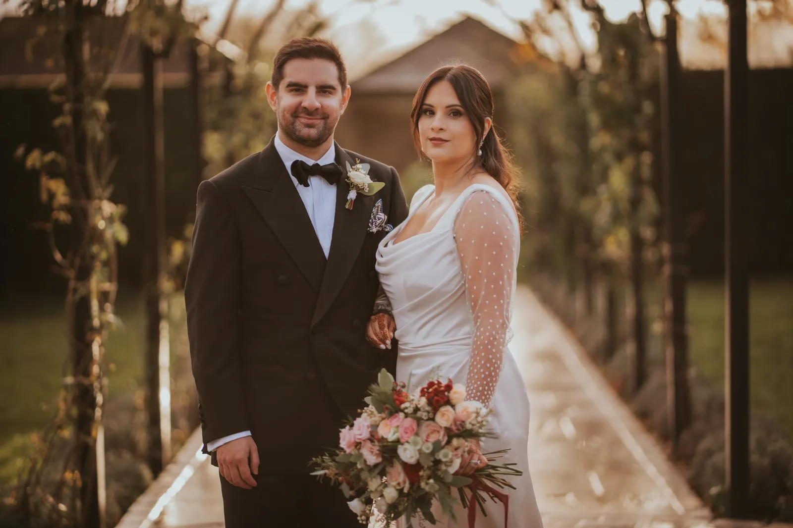 Vintage-style satin draped wedding gown with built-in corset and detachable silk sleeves