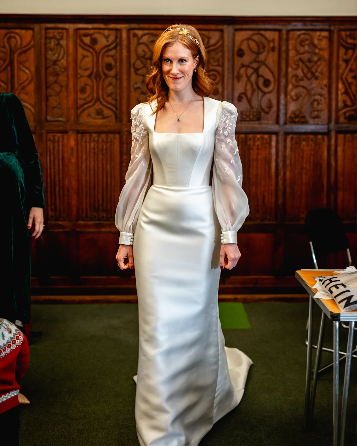 Hermione in her bespoke satin wedding dress with a square neckline and sheer embroidered puff sleeves