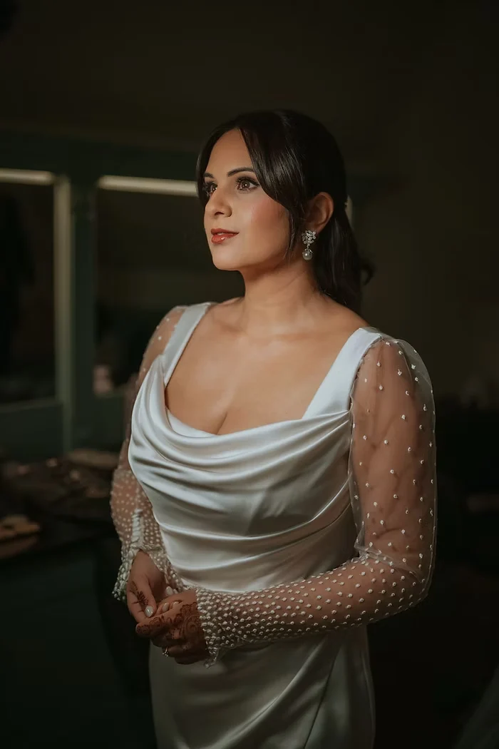 Custom Italian silk wedding gown with all-over lace, front view in the chateau dressing room